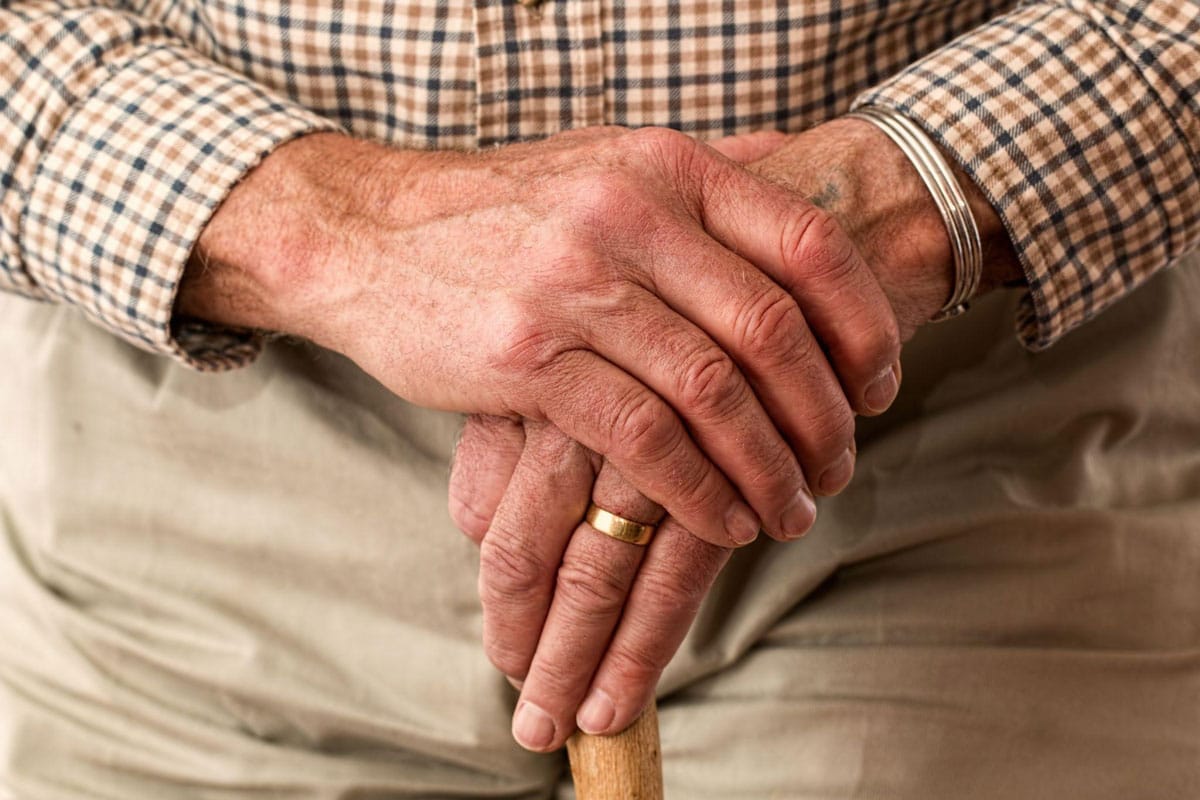 Old-man-hand-on-hand old man hand on hand